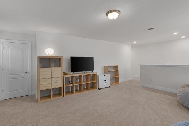 Carpeted living area with recessed lighting | Image 16