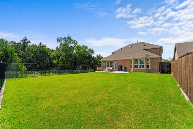 Fenced backyard featuring a patio area | Image 33