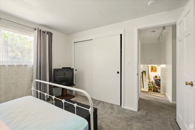 Bedroom with carpet, a closet, and baseboards | Image 21