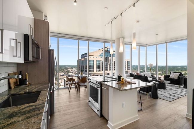 With two walls of uninterrupted glass meeting at the NE corner, this home offers non-stop views of downtown Nashville and beyond. New wide, plank European white oak flooring accentuates the warmth and abundance of natural light. | Image 7