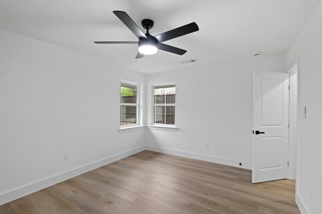Spare room with baseboards, ceiling fan, visible vents, and light wood-style floors | Image 23