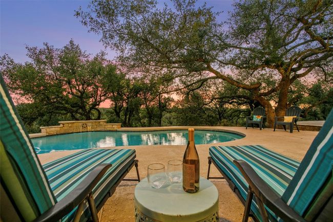 Pool at dusk featuring an outdoor pool and a patio area | Image 19