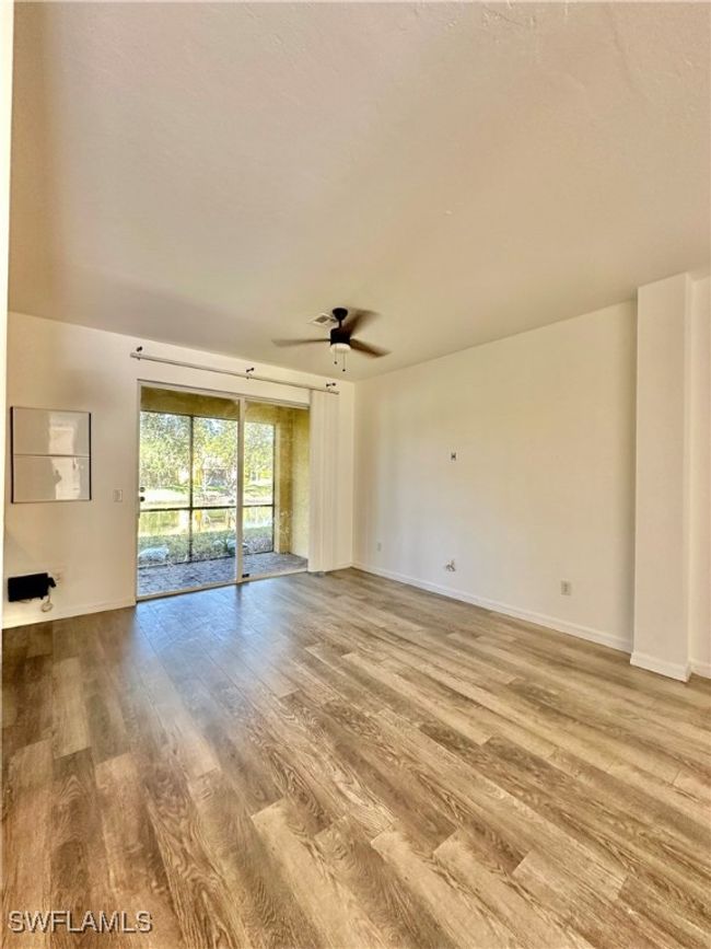 Spare room featuring wood-type flooring and ceiling fan | Image 5