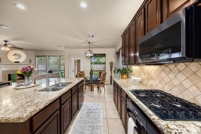 The counter space is endless here. You have a newly installed modern microwave, dishwasher and garbage disposal, all recently installed. You have a gas range and oven. | Image 17