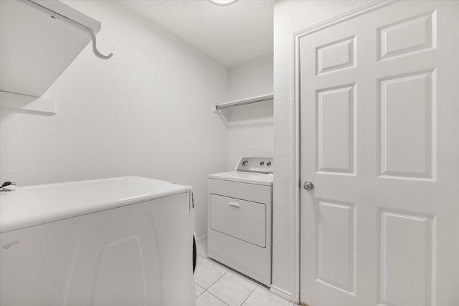 Washroom with separate washer and dryer and light tile patterned floors | Image 21