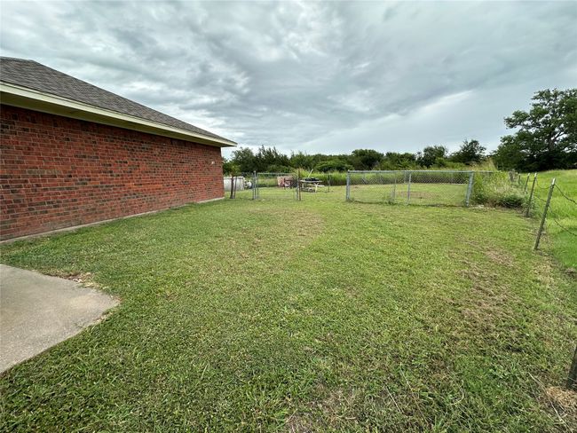View of yard with a gate | Image 25