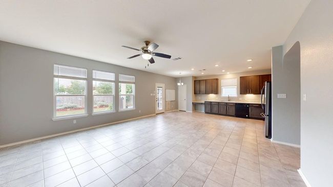 Unfurnished living room featuring a healthy amount of sunlight, baseboards, ceiling fan, and recessed lighting | Image 21