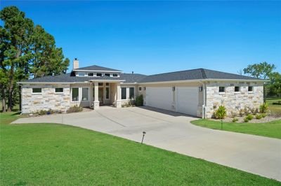 Very nice (almost new) single story stone and stucco home located on almost two acres with Lake Conroe access! | Image 1