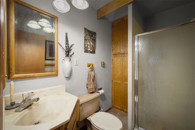 Bathroom with a shower stall, vanity, and toilet | Image 36