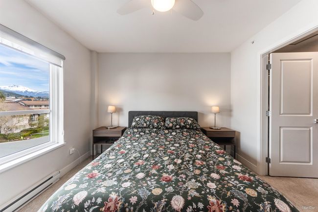 Bedroom featuring ceiling fan, baseboards, carpet floors, and a baseboard radiator | Image 20