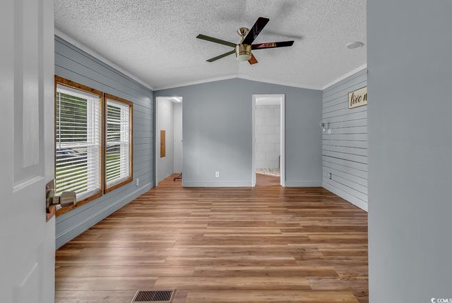 Laundry room with independent washer and dryer and wooden walls | Image 10