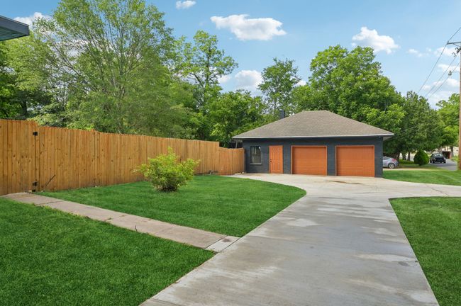 View of front of property with a detached garage and a shingled roof | Image 36