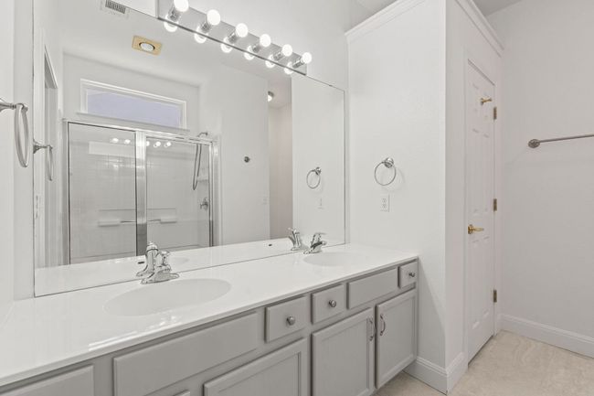 Full bath with double vanity, visible vents, a sink, and a shower stall | Image 24