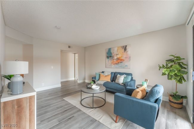 Living room with light wood-type flooring | Image 5