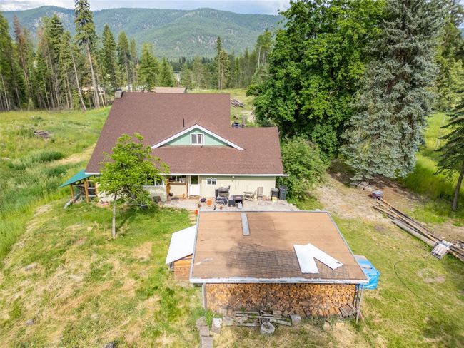 View from above of property featuring a mountainous background and a forest | Image 10