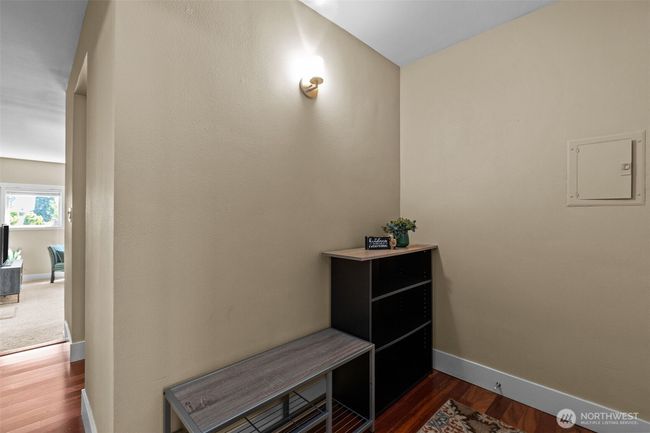 Nice, well-lit entryway. I immediately noticed the engineered hardwood floors. There is also very easy access to your power box here. | Image 6