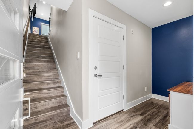 Upon entrance, floors to the second floor living/kitchen, garage entrance to condo, mud area | Image 4