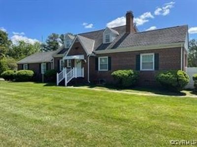 Cape cod house with a front lawn | Image 1