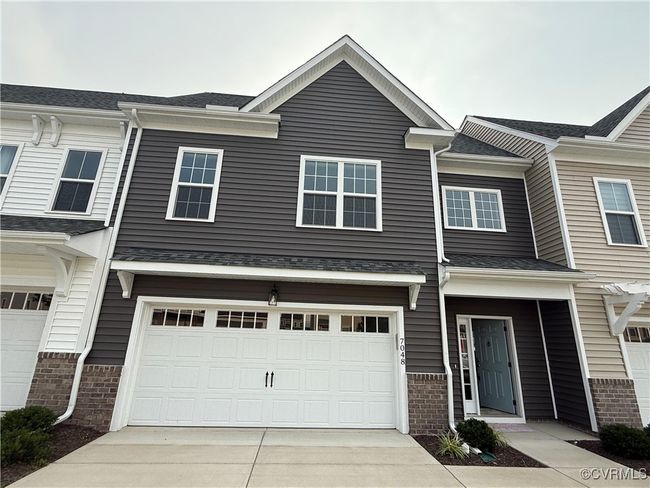 View of property featuring a garage, driveway, and brick siding | Image 28