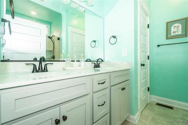 Full bathroom with a sink, baseboards, walk in shower, and visible vents | Image 20