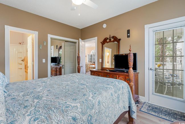 Bedroom featuring a closet, connected bathroom, light hardwood / wood-style floors, and ceiling fan | Image 11