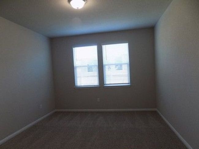 Empty room with dark carpet and baseboards | Image 10