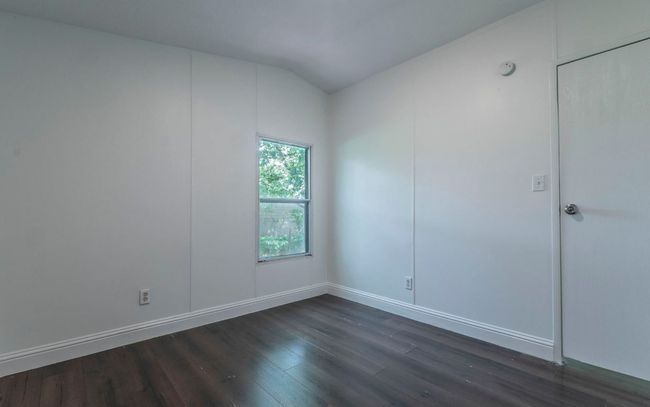 Unfurnished room featuring dark wood-type flooring and vaulted ceiling | Image 12