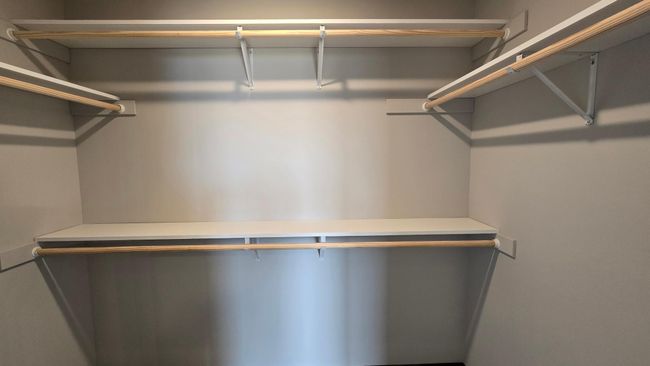 The primary bedroom walk in closet offers double rodding for more storage. | Image 18