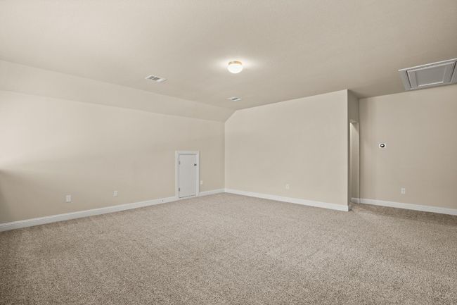 Bonus room with lofted ceiling, attic access, visible vents, light carpet, and baseboards | Image 19
