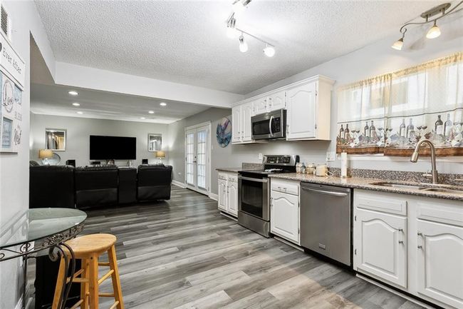 Kitchen with view into den | Image 4