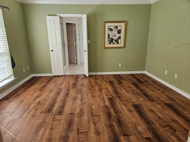 Unfurnished room with crown molding and wood finished floors | Image 11