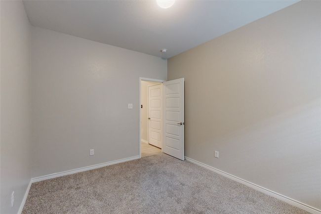 Unfurnished room with light colored carpet and baseboards | Image 32