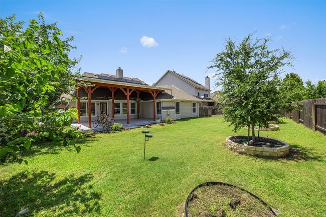 Fenced backyard with a patio | Image 34