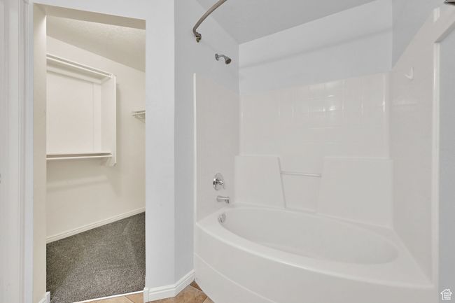 Bathroom with shower combination and a walk in closet | Image 22