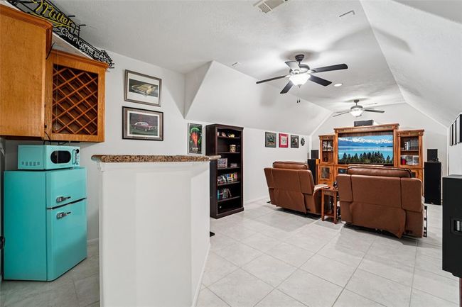 Upstairs media room complete with dry bar area and built-in wine rack. Microwave/mini-fridge are included! | Image 36