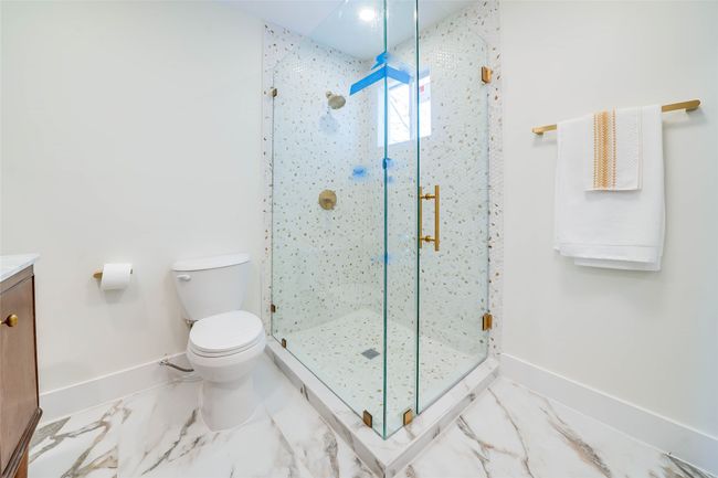 Bathroom featuring vanity, toilet, and walk in shower | Image 22