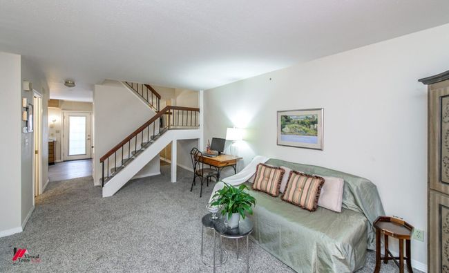 Carpeted living area featuring baseboards and stairs | Image 8