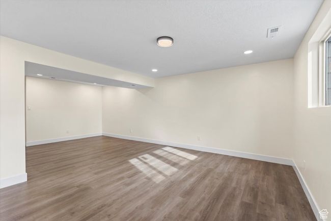 Basement featuring baseboards, visible vents, recessed lighting, and wood finished floors | Image 18