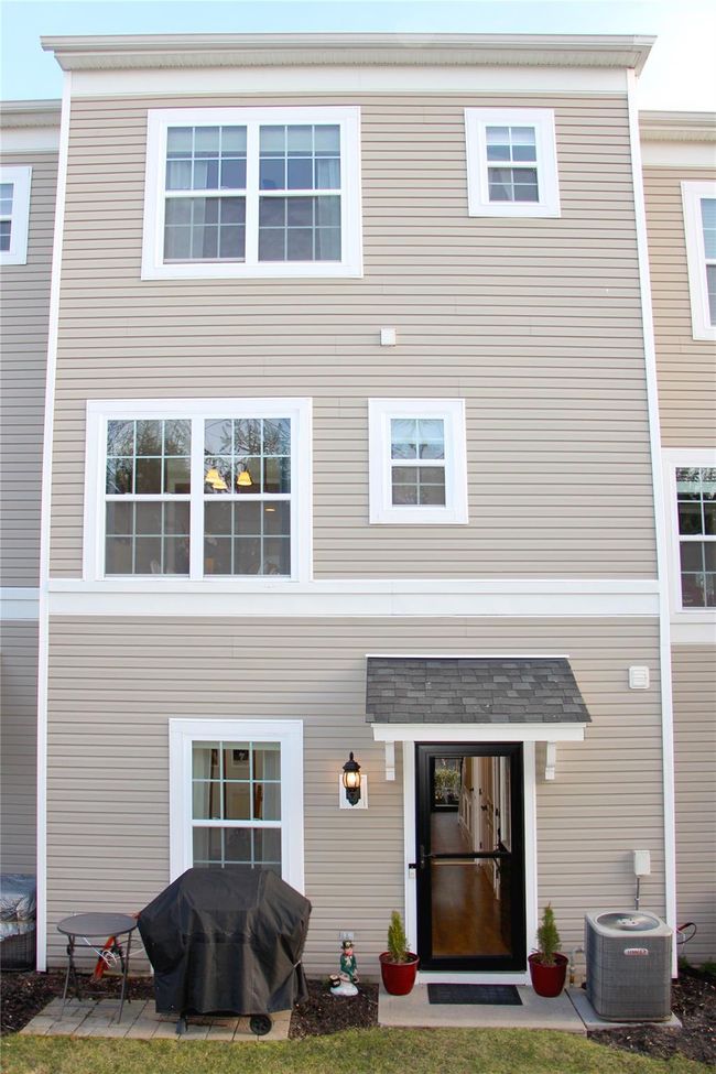 Rear view of house featuring central air condition unit and a patio area | Image 25
