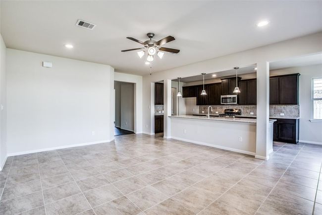 Modern kitchen with dark cabinets and endless counter space | Image 8