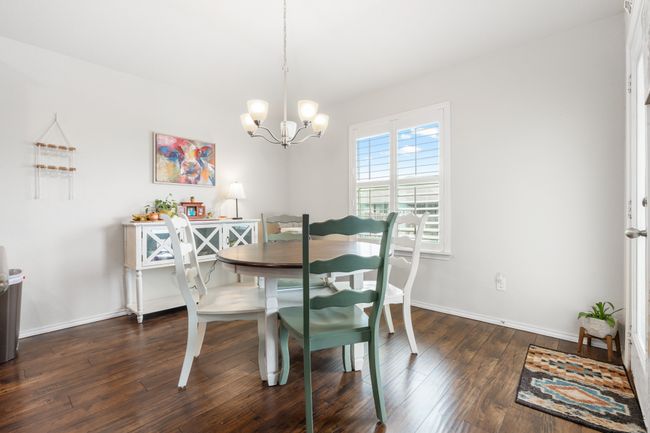 Dining space with a chandelier, wood finished floors, and baseboards | Image 16