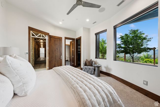 Carpeted bedroom with recessed lighting, baseboards, a ceiling fan, and ensuite bathroom | Image 83