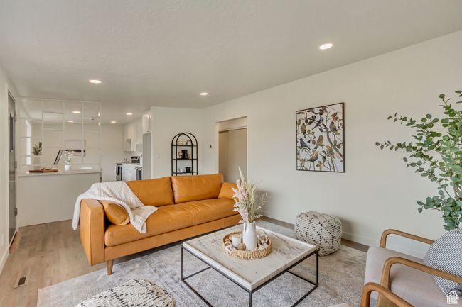 Living room with baseboards, light wood-style flooring, visible vents, and recessed lighting | Image 5