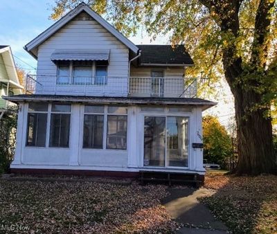 Front view of property featuring an open porch up and an enclosed porch down. | Image 2