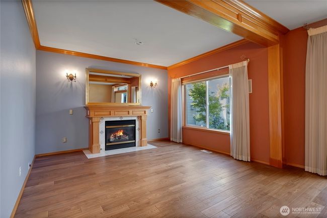 Upgraded milwork surrounds the gas fireplace | Image 10