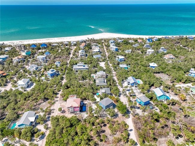 Birds eye view of property with a water view and a beach view | Image 45