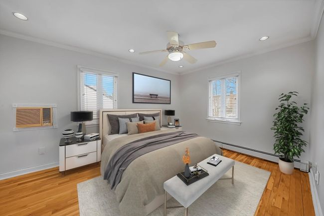 Bedroom Virtually Staged for Concept featuring ceiling fan, a wall unit AC, crown molding, and light hardwood / wood-style floors | Image 16