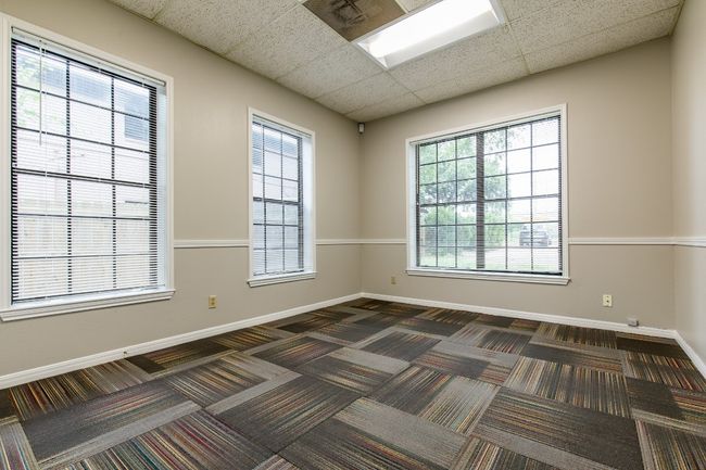 Spare room with baseboards and dark colored carpet | Image 7