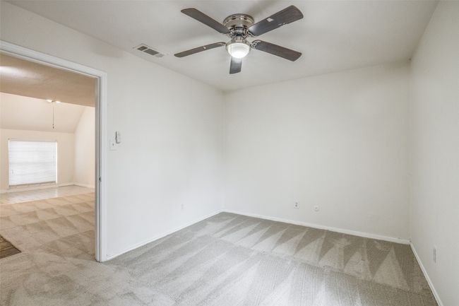 Carpeted spare room featuring ceiling fan and baseboards | Image 17