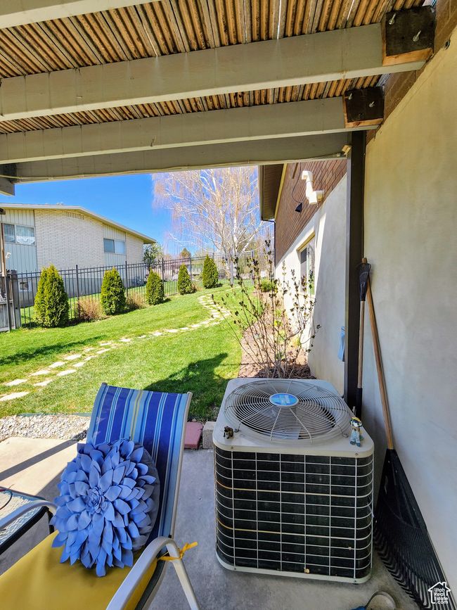 Exterior details with stucco siding, central air condition unit, and fence | Image 49